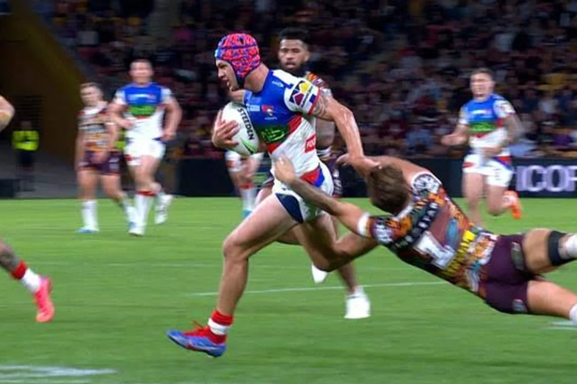 One NRL player brushing off a tackle by another player
