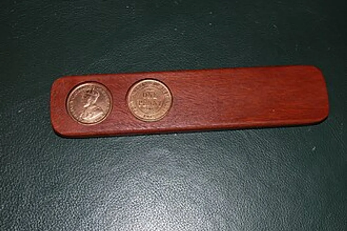 a two-up set featuring a leather-bound kip and two 1915 Australian pennies